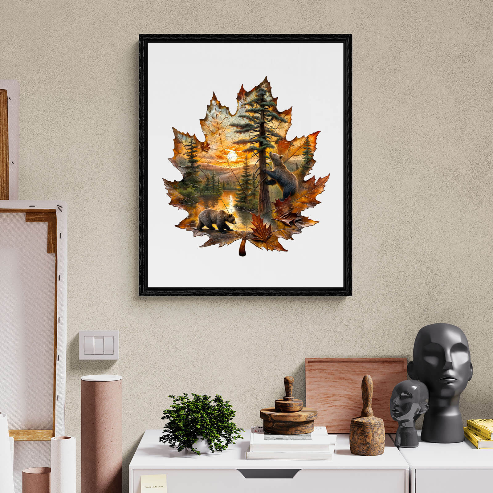 Wooden jigsaw puzzle featuring brown bears in autumn landscape, framed leaf design with sunset and pine trees.