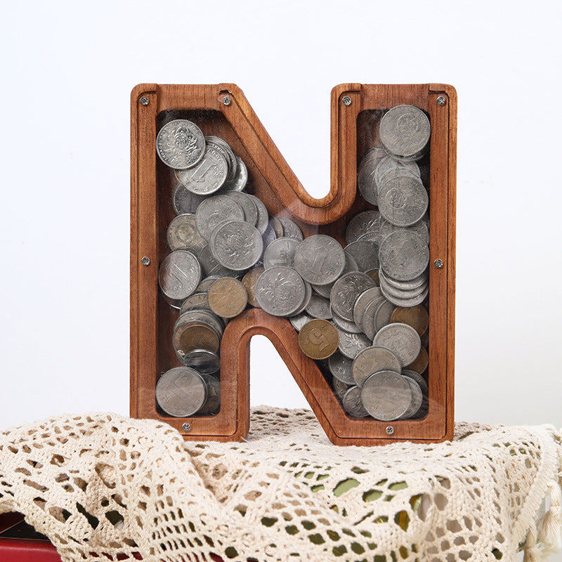 Personalised wooden letter piggy bank 'N' filled with coins, great gift for teaching kids money management.
