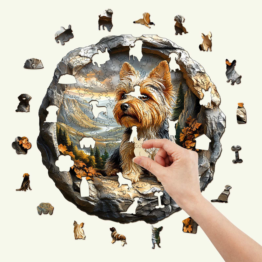 Hand completing a 3D Yorkshire dog puzzle, featuring a scenic background and various animal-shaped pieces.
