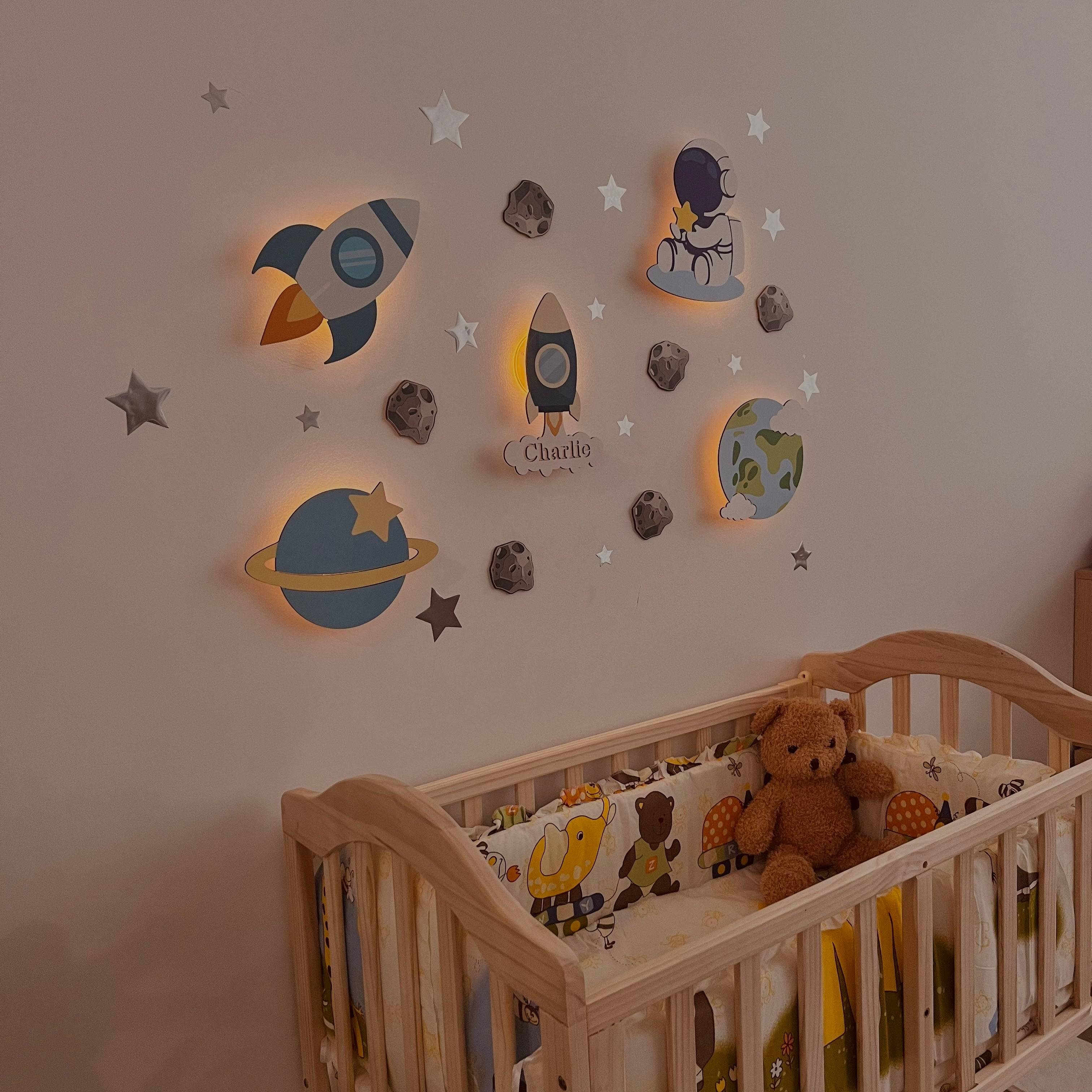 Personalized wooden baby room wall light set featuring space-themed designs, ideal for comforting nighttime glow.