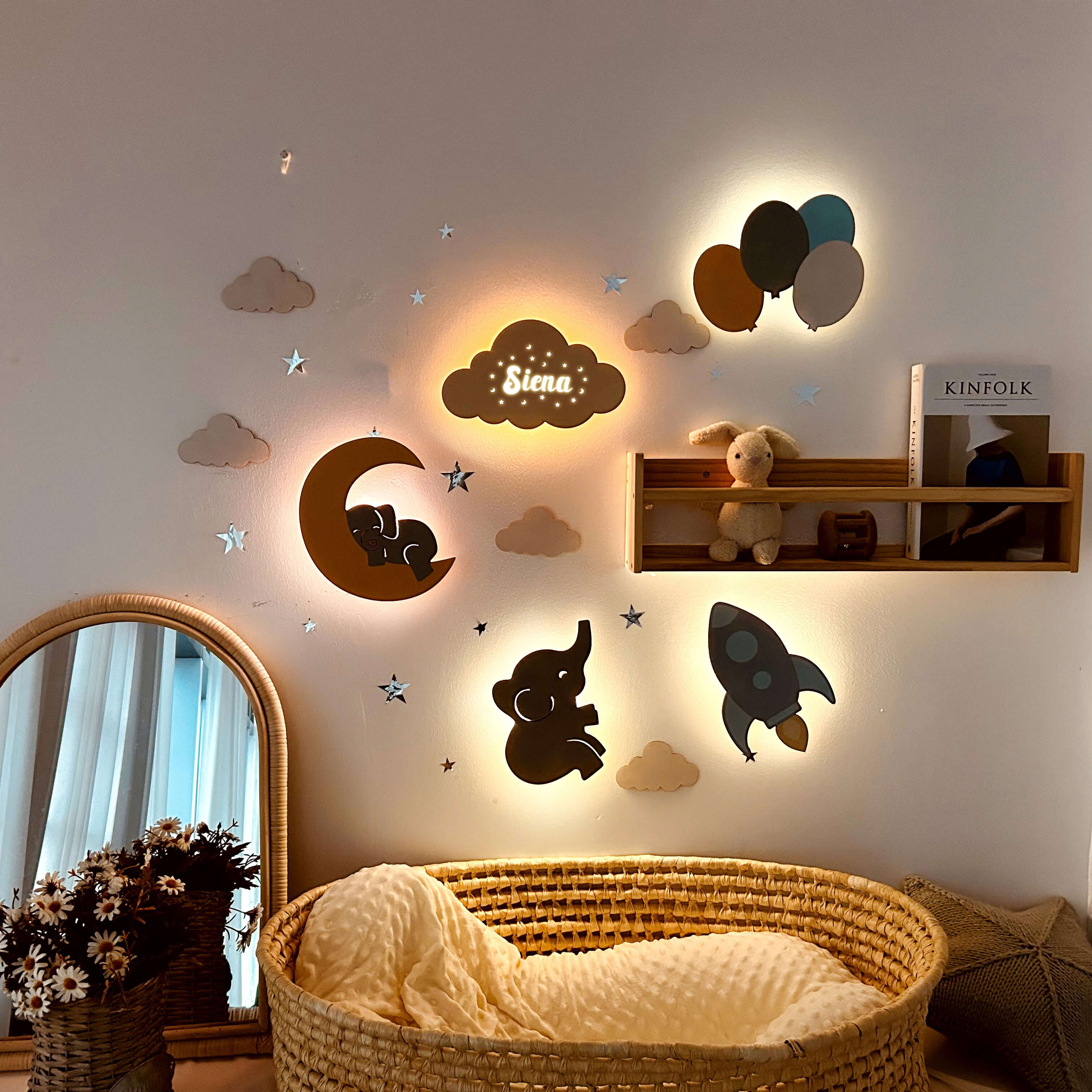 Personalized wooden wall lights in baby's room, featuring elephants, rockets, and soft glow for a comforting atmosphere.