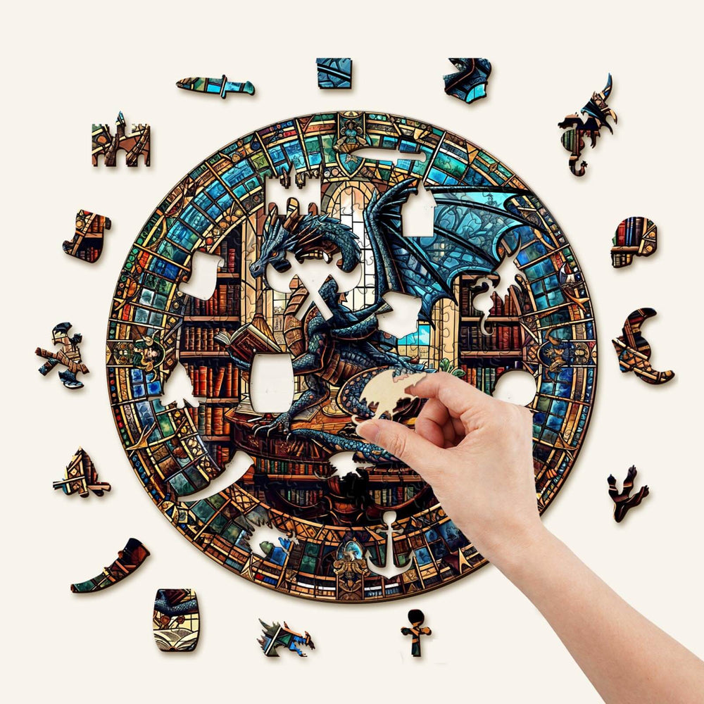 Hand assembling The Dragon's Library wooden jigsaw puzzle featuring a colorful dragon and intricate library designs.