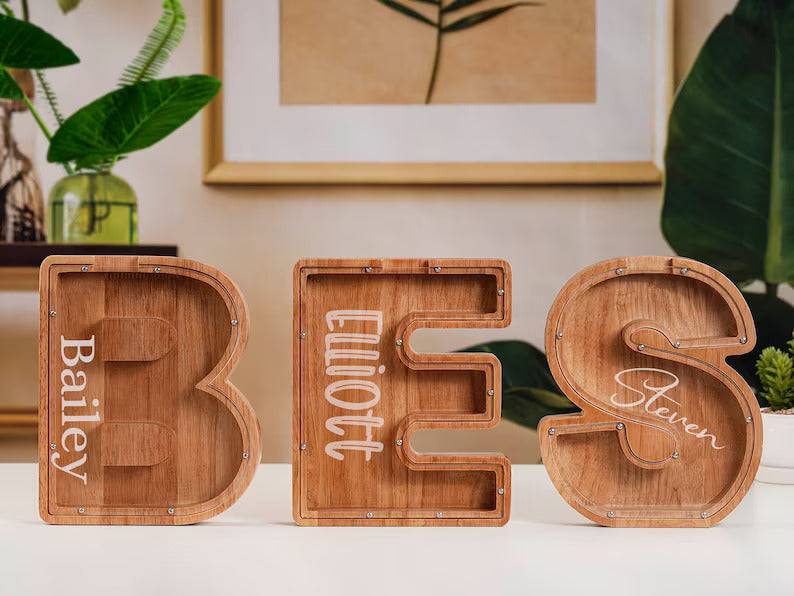 Personalized wooden letter piggy banks displayed, showcasing kids' names for unique gifting.