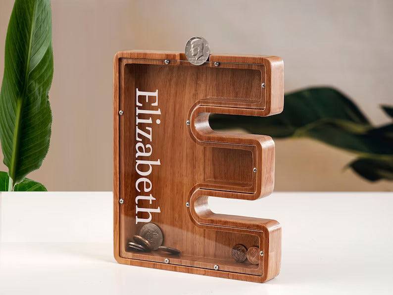 Personalized wooden letter piggy bank for kids, featuring the name Elizabeth, perfect for teaching financial literacy.