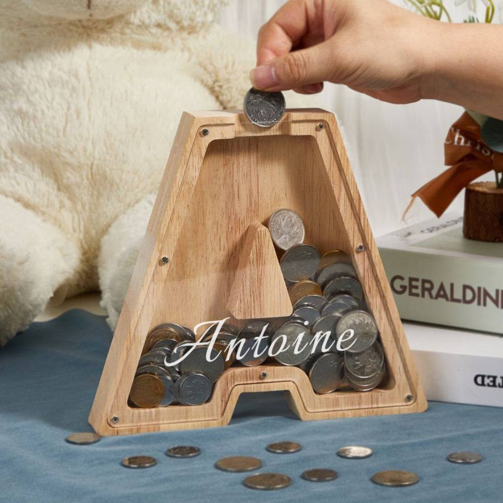 Custom wooden letter piggy bank with coins, personalized gift for kids, teaching savings and financial awareness.