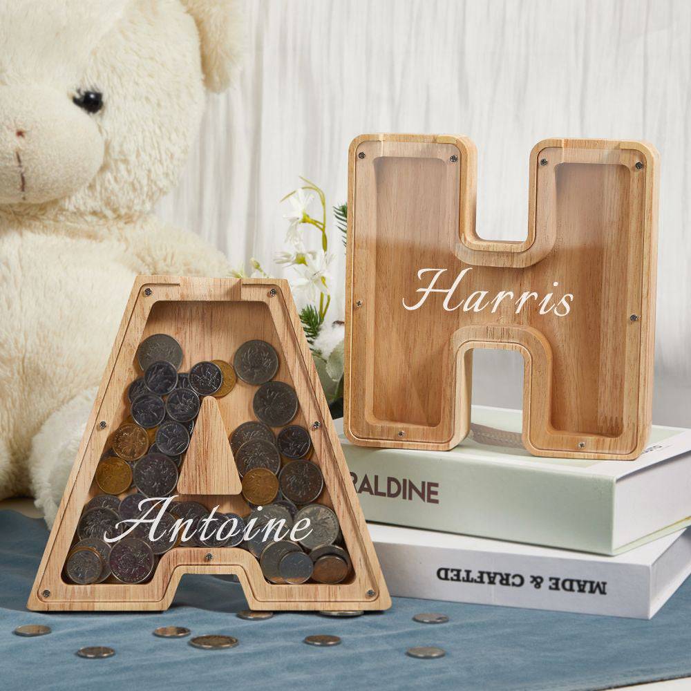 Custom wooden piggy bank letters A and H filled with coins, personalized for kids' savings education.