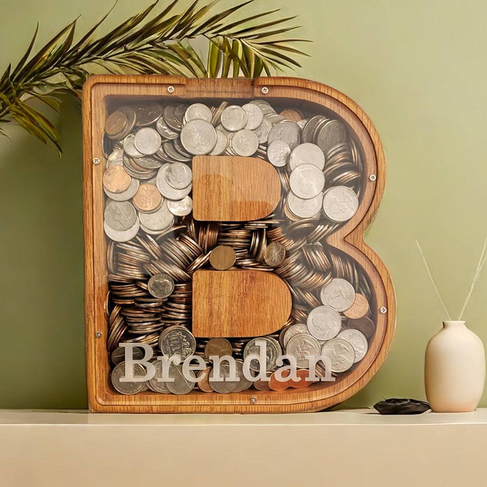 Custom wooden letter piggy bank for kids with coins inside, personalized with the name Brendan.