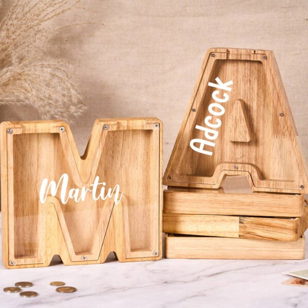 Personalized wooden letter piggy bank with name 'Martin' for teaching kids savings and financial awareness.