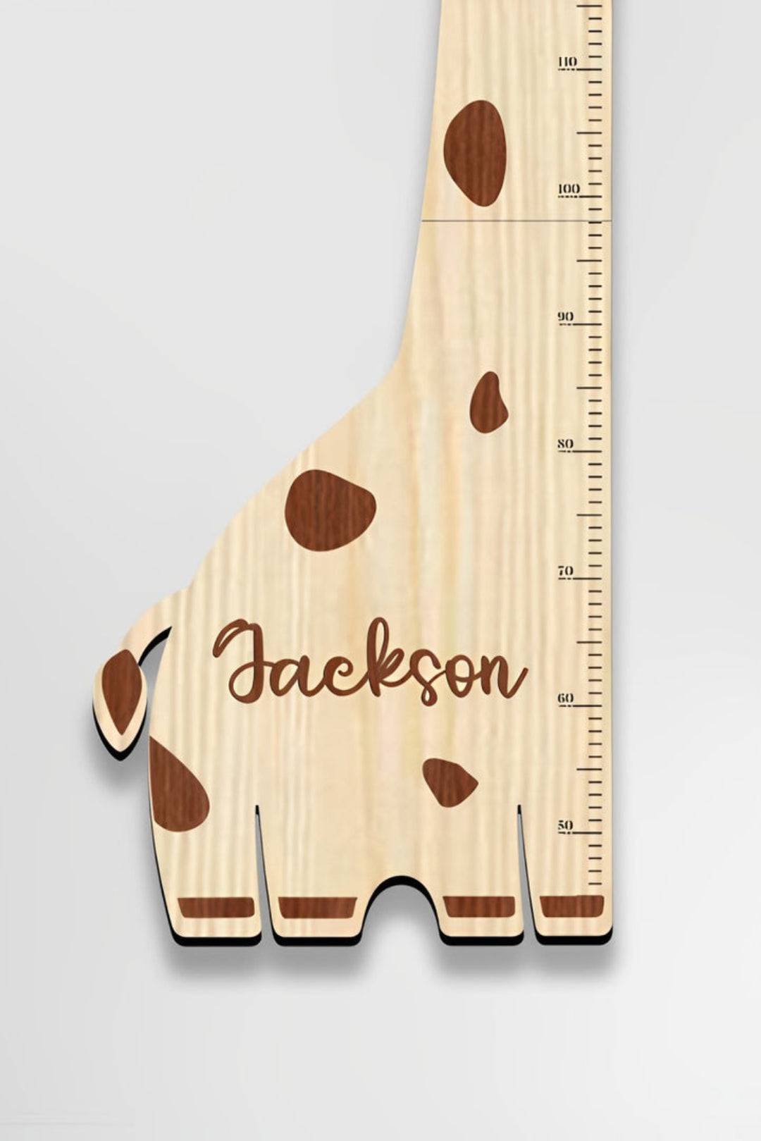 Personalized wooden giraffe growth chart with height measurements, featuring the name Jackson.